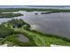 Aerial view of waterfront property and lush landscape at 4799 Independence Dr, Bradenton, FL 34210