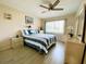 Bedroom with queen-size bed, ceiling fan, and dresser at 4799 Independence Dr, Bradenton, FL 34210