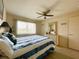 Bedroom with a queen bed, ceiling fan, and dresser at 4799 Independence Dr, Bradenton, FL 34210