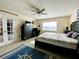 King-size bed, ceiling fan, and access to a second room at 4799 Independence Dr, Bradenton, FL 34210