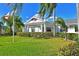 Community clubhouse with columns and lush landscaping at 4799 Independence Dr, Bradenton, FL 34210