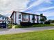 Exterior view of condo building showcasing a unit's entrance and parking at 4799 Independence Dr, Bradenton, FL 34210