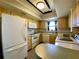 Well-equipped kitchen, featuring white appliances and light wood cabinets at 4799 Independence Dr, Bradenton, FL 34210