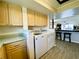 Bright laundry room with washer and dryer, built-in cabinets, and light countertops at 4799 Independence Dr, Bradenton, FL 34210