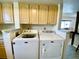 Well lit laundry area with washer, dryer, and ample cabinetry at 4799 Independence Dr, Bradenton, FL 34210