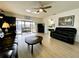 Spacious living room featuring leather furniture and wood-look floors at 4799 Independence Dr, Bradenton, FL 34210