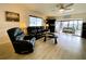 Bright living room with leather furniture, wood-look floors, and access to a balcony at 4799 Independence Dr, Bradenton, FL 34210