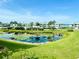 Lovely view of the community's pond and lush green landscaping at 4799 Independence Dr, Bradenton, FL 34210