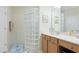 Bathroom with glass block shower and wood vanity at 4820 Lakescene Pl, Sarasota, FL 34243