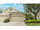 Two-car garage, attractive landscaping, and a welcoming front entrance at 4820 Lakescene Pl, Sarasota, FL 34243