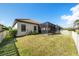 Landscaped backyard featuring a large screened patio at 491 Casalino Dr, Nokomis, FL 34275