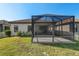 Private backyard with screened patio and grassy area at 491 Casalino Dr, Nokomis, FL 34275
