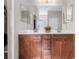 Double vanity bathroom with wood cabinets and a large mirror at 491 Casalino Dr, Nokomis, FL 34275