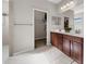 Bathroom with double vanity, walk-in closet, and tile flooring at 491 Casalino Dr, Nokomis, FL 34275