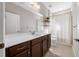 Clean bathroom with a brown vanity and a bathtub at 491 Casalino Dr, Nokomis, FL 34275