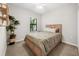 Guest bedroom with a full-size bed and leafy plants at 491 Casalino Dr, Nokomis, FL 34275