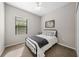 Well-lit bedroom with a metal bed frame and closet at 491 Casalino Dr, Nokomis, FL 34275