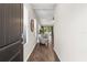 Home entryway with dark door, hardwood floors, and view into living area at 491 Casalino Dr, Nokomis, FL 34275
