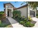 Front view of a house with walkway, landscaping and a two-car garage at 491 Casalino Dr, Nokomis, FL 34275