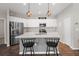 Modern kitchen with white cabinets, stainless steel appliances, and an island at 491 Casalino Dr, Nokomis, FL 34275
