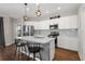 Bright kitchen boasts white cabinetry, stainless steel appliances, and a large island at 491 Casalino Dr, Nokomis, FL 34275