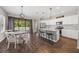 Kitchen with island, white cabinets, stainless steel appliances and dining area at 491 Casalino Dr, Nokomis, FL 34275