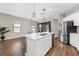 Open kitchen features a large island with quartz countertop and stainless steel appliances at 491 Casalino Dr, Nokomis, FL 34275