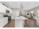Modern kitchen with island, stainless steel appliances, and light wood flooring at 491 Casalino Dr, Nokomis, FL 34275