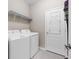 Clean laundry room with washer, dryer, and shelving at 491 Casalino Dr, Nokomis, FL 34275