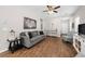 Living room with hardwood floors, gray sofa, and a view into the entryway at 491 Casalino Dr, Nokomis, FL 34275