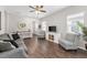 Living room with hardwood floors, gray sofas and a view of the entryway at 491 Casalino Dr, Nokomis, FL 34275