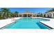 Community pool and clubhouse with comfortable lounge seating providing an inviting space for relaxation and enjoyment at 5034 Maymont Park Cir, Bradenton, FL 34203