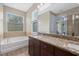 Double vanity bathroom with soaking tub and granite countertop at 5307 Applegate Ct, Bradenton, FL 34211