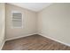 Small bedroom with wood-look floors and window at 5307 Applegate Ct, Bradenton, FL 34211