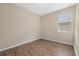 Simple bedroom with wood-look floors and window at 5307 Applegate Ct, Bradenton, FL 34211