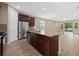 Kitchen with an island, stainless steel appliances, and dark wood cabinets at 5307 Applegate Ct, Bradenton, FL 34211