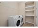 Laundry room with washer, dryer, shelving and hanging rod at 5307 Applegate Ct, Bradenton, FL 34211