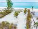 Aerial view of beachfront property with a picnic table and trees at 531 Edlee Ln, Longboat Key, FL 34228