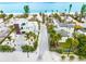 Aerial view of two modern beachfront homes with paved driveways at 531 Edlee Ln, Longboat Key, FL 34228