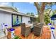 Relaxing patio with wooden deck and wicker furniture at 531 Edlee Ln, Longboat Key, FL 34228
