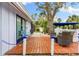 Relaxing patio with wooden deck and wicker furniture at 531 Edlee Ln, Longboat Key, FL 34228