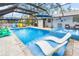 Large screened pool area with spa and lounge chairs at 531 Edlee Ln, Longboat Key, FL 34228