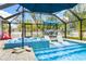 Inviting pool and spa with lounge chairs and umbrella at 531 Edlee Ln, Longboat Key, FL 34228