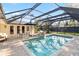 Inviting pool area with spa and screened enclosure at 600 Owl Way, Sarasota, FL 34236