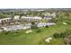 Aerial perspective showcasing community layout and golf course at 6114 43Rd W St # 104E, Bradenton, FL 34210