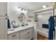 Modern bathroom with white vanity, round mirror, and a glass shower at 6114 43Rd W St # 104E, Bradenton, FL 34210