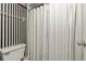 Clean bathroom with white shower curtain and black and white striped walls at 6114 43Rd W St # 104E, Bradenton, FL 34210