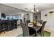 Dining area with a dark wood table and chairs, and views into living room at 6114 43Rd W St # 104E, Bradenton, FL 34210