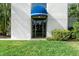 Building entrance with blue awning and landscaping at 6114 43Rd W St # 104E, Bradenton, FL 34210