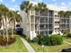 Exterior of condo building with palm trees and walkway at 6114 43Rd W St # 104E, Bradenton, FL 34210